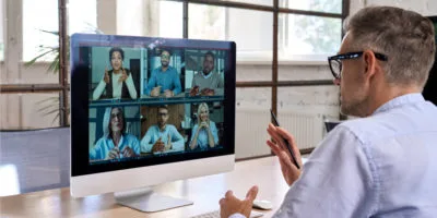 man at desk on virtual call